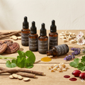 Bottles of 'The Eight' skincare product on a wooden surface with natural ingredients.